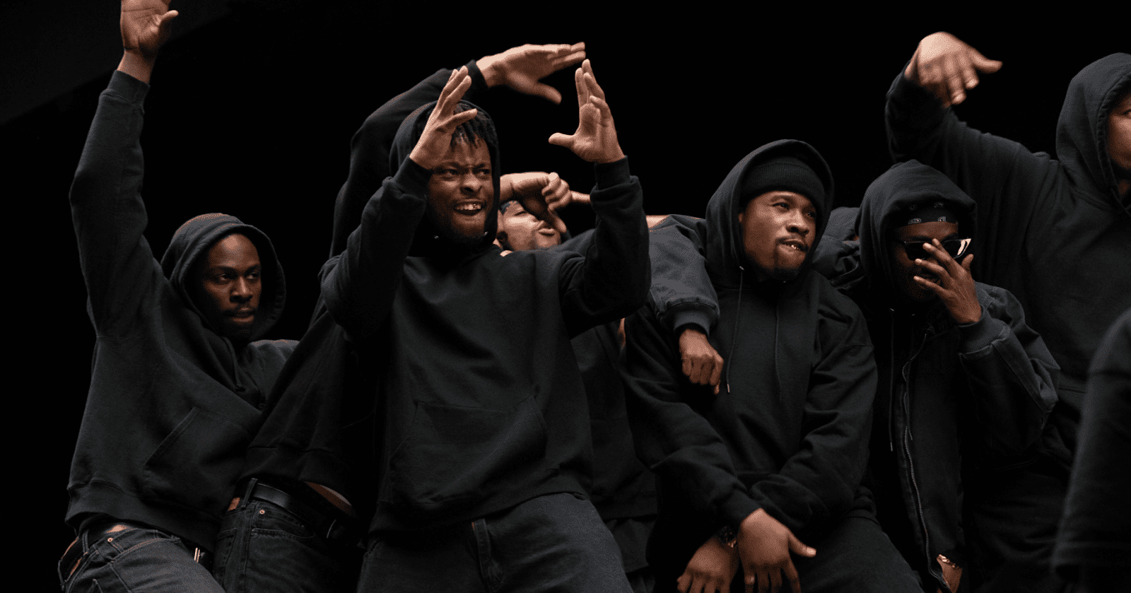  A group of young men dancing to what appears to be hip-hop