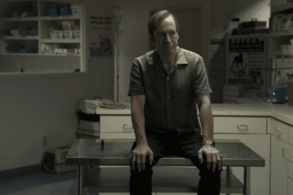 Bob Odenkirk sitting on a metal table