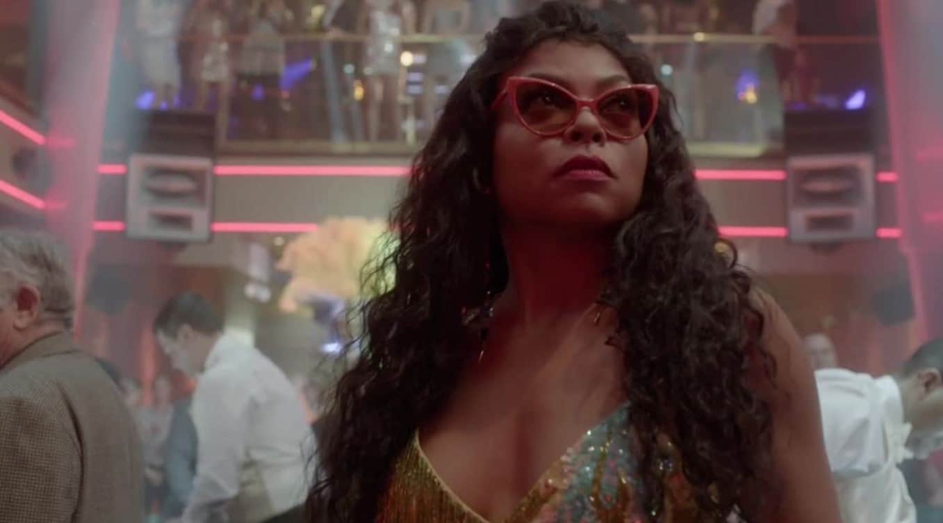 Cookie Lyon in a club with curly hair, red sunglasses, and a sparkly dress