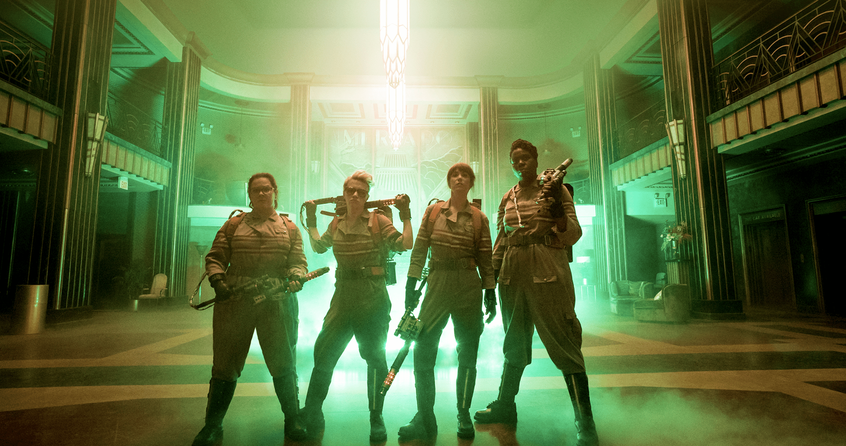 The main characters of the movie Ghostbusters pose in their costumes.