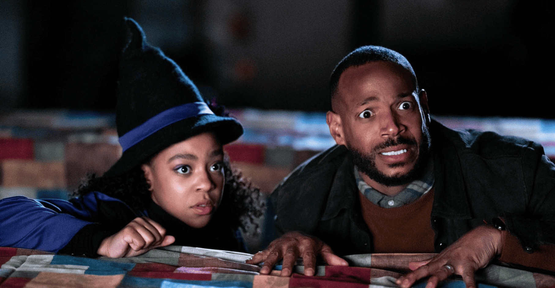 Marlon Wayans and Priah Ferguson crouching while presumably looking at something scary in this image from Ugly Baby Productions.