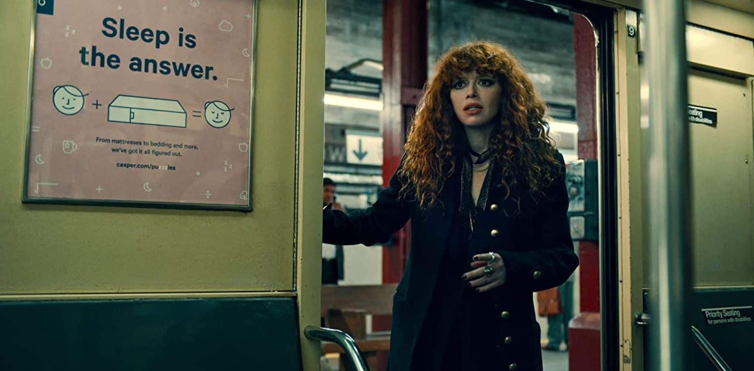 Nadia Vulvokov leaning out of a New York subway looking perplexed