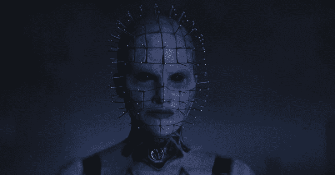 A human-esque monster with pins stuck to its face in a grid design in this image from 20th Century Studios. 