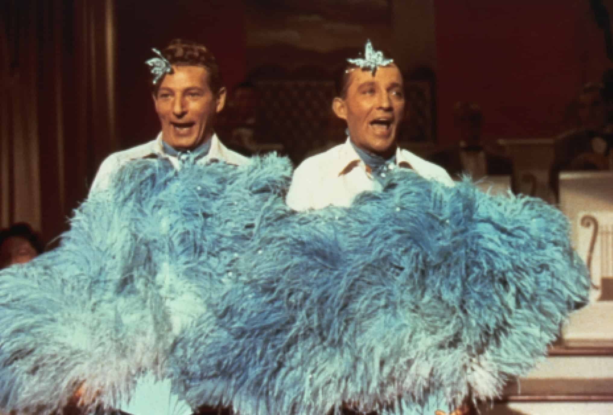 Phil and Bob don blue feathers for a performance.