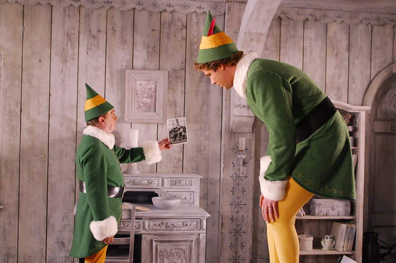 Papa Elf shows Buddy a picture of Buddy’s biological parents