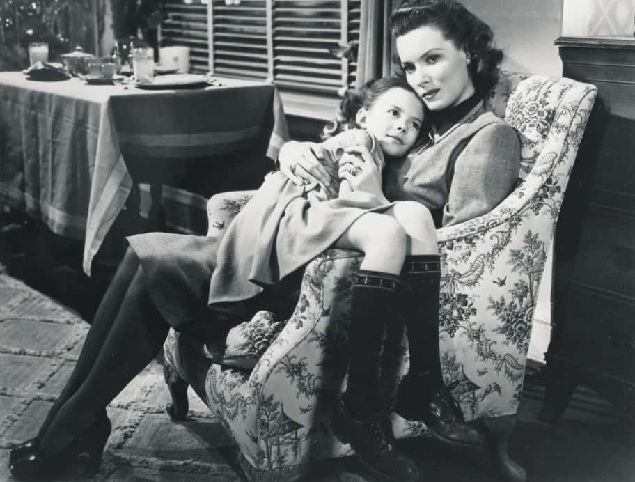 A daughter snuggles in her mother's lap in this image from Twentieth Century Fox. 