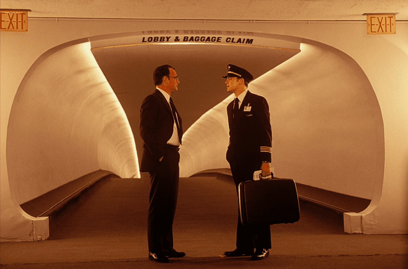 Two men, one in a suit and one in a pilot’s uniform, butt heads at an airport in this image from DreamWorks Pictures. 