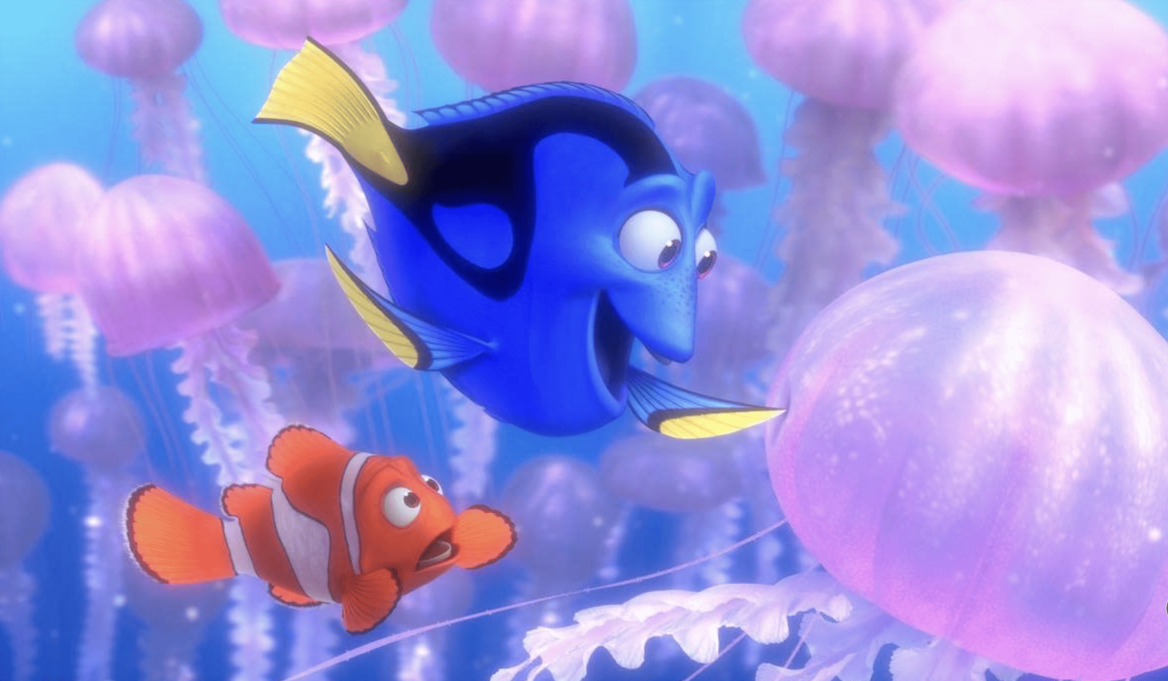 An animated clownfish is horrified when a blue tang pokes a jellyfish in this image from Pixar Animation Studios. 