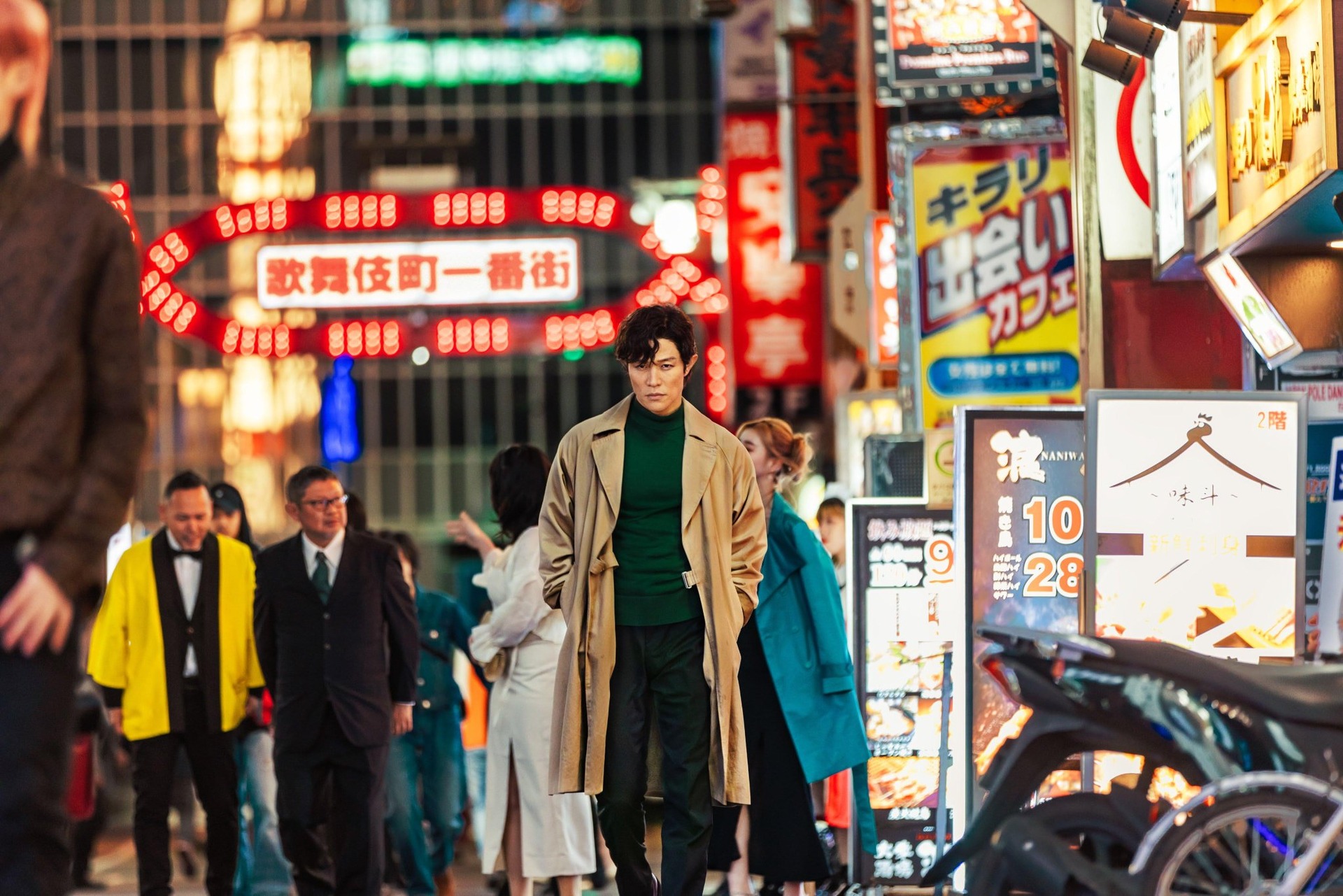 A man in a trench coat on a Tokyo street in this image from Horipro.