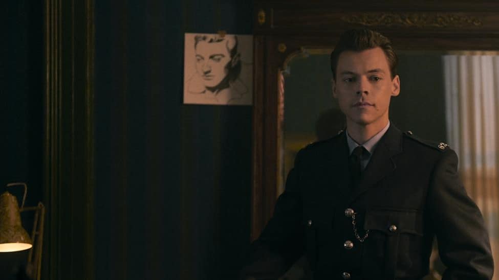 Tom facing away from a mirror in his police uniform