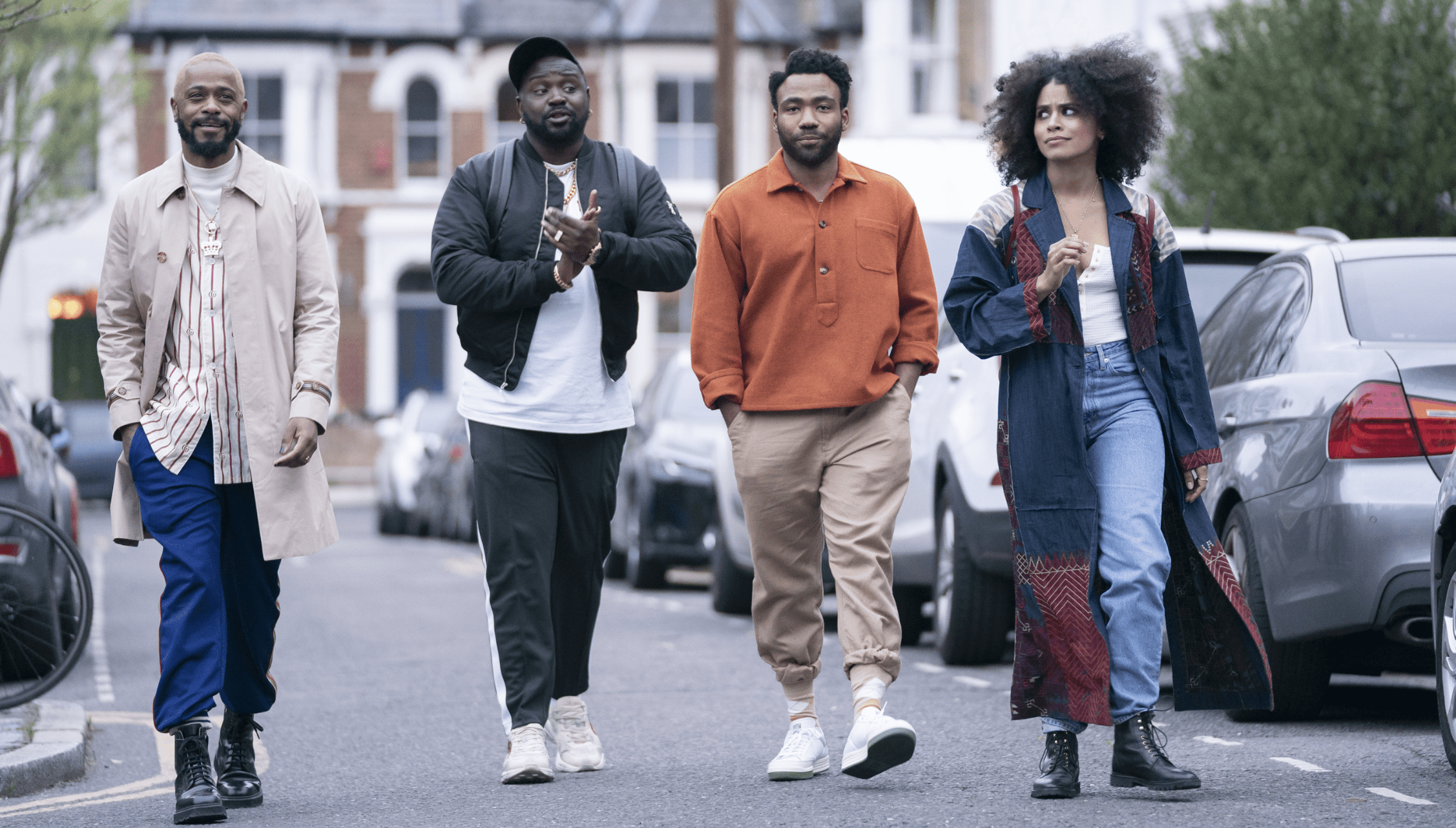 The four main characters of the show Atlanta walk through a street.