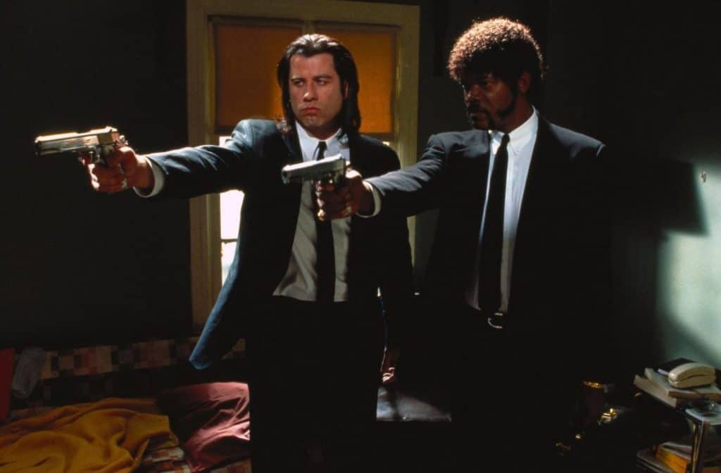 Hitmen Vincent Vega and Jules Winnfield pointing their guns in the same direction