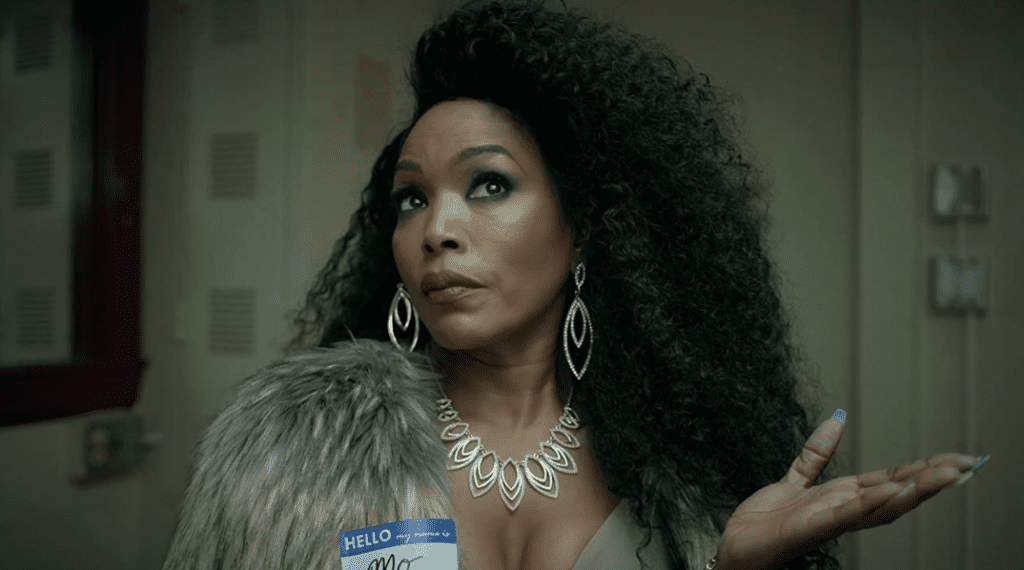 Mo (Angela Bassett) gesturing expectantly with an open palm, waiting