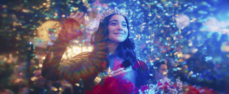 Ms. Marvel waving while wearing a sparkling crown