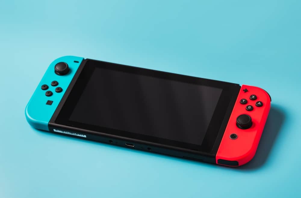 A Nintendo Switch console against a light-blue background