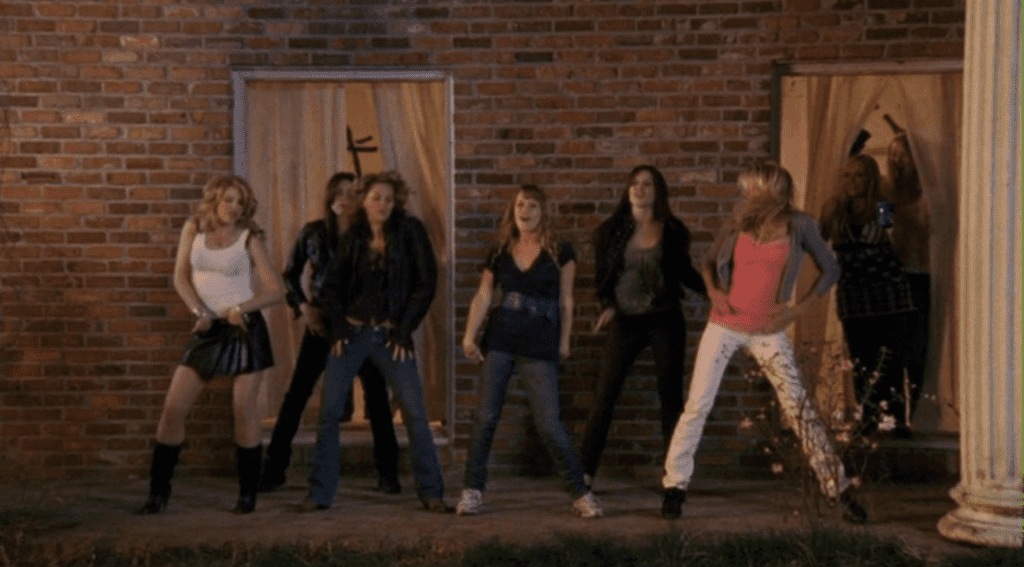 The show’s female cast dancing outside at a party