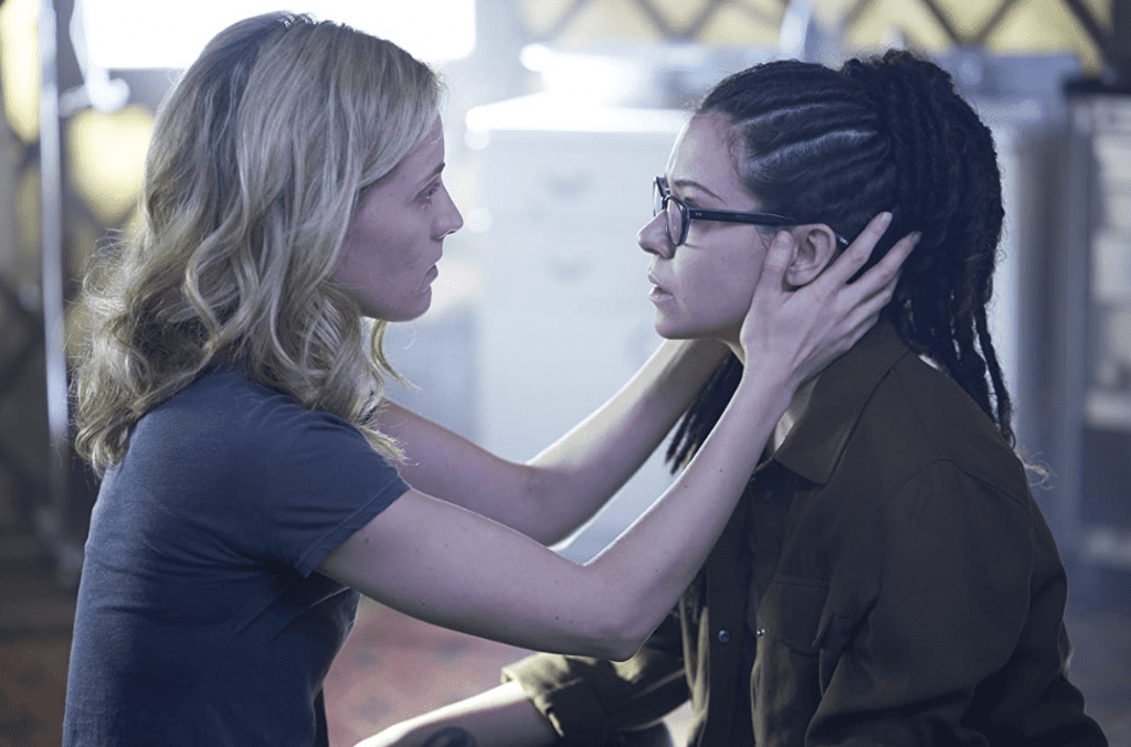 A woman holds another woman’s head as they face each other in this image from Temple Street Productions.