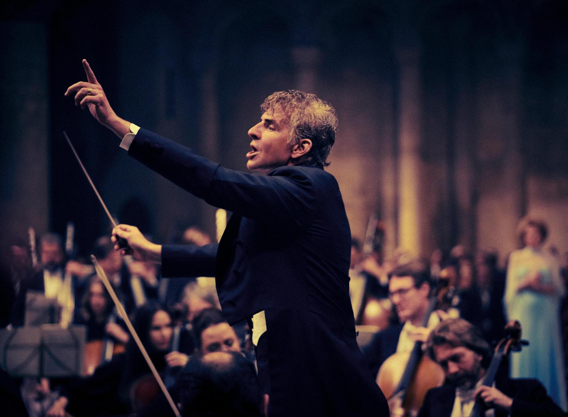 A man passionately conducting an orchestra in this image from Sikelia Productions.