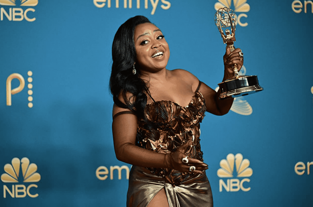 Quinta Brunson posing for a photo with her new Emmy Award