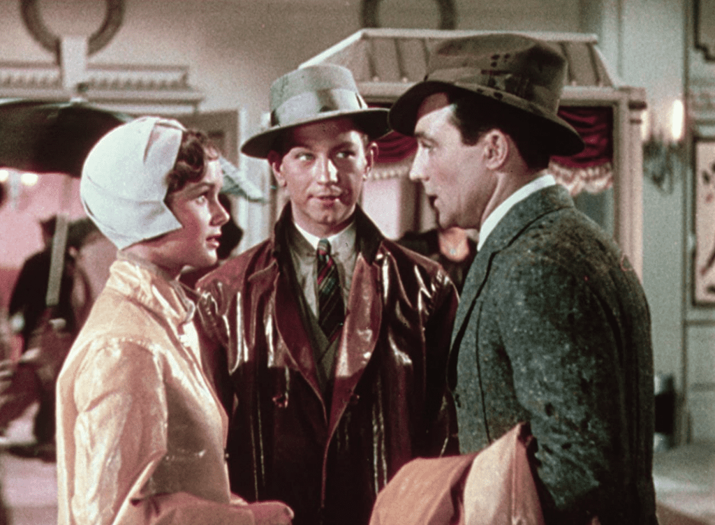 Debbie Reynolds, Donald O’Connor, and Gene Kelly in a group discussion