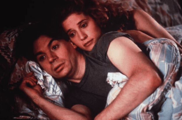 A man and woman lay in bed together in this image from TriStar Pictures.