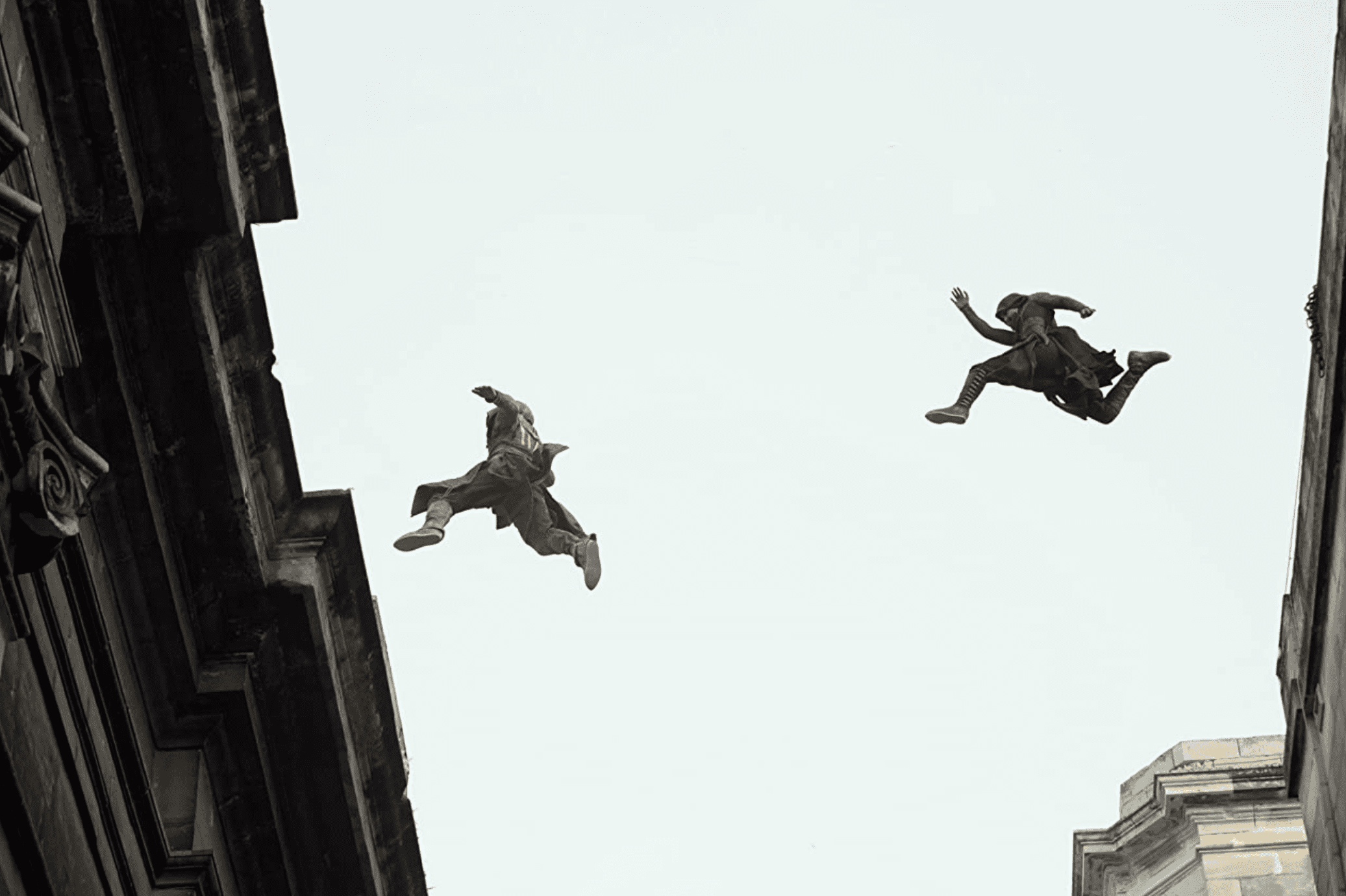 Cal leaps across buildings with Maria close behind