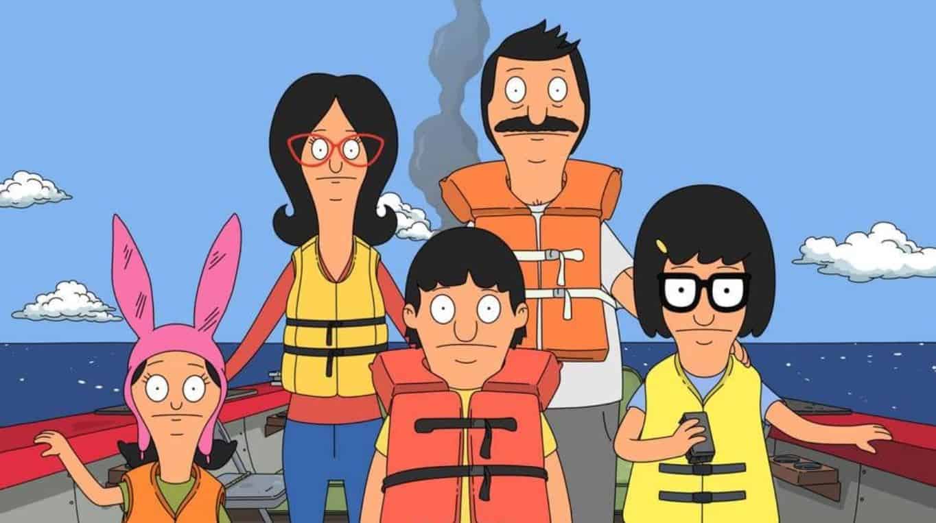 The Belcher Family stands on a boat in the ocean while wearing life jackets