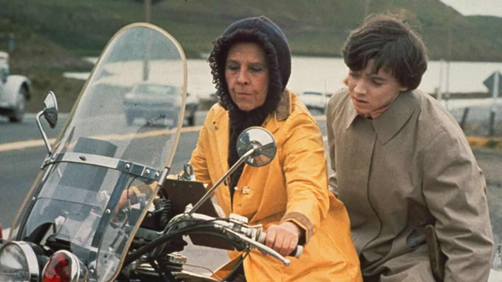 An older woman in a yellow coat and a young man in a brown coat sitting on a motorcycle in this image from Paramount Pictures