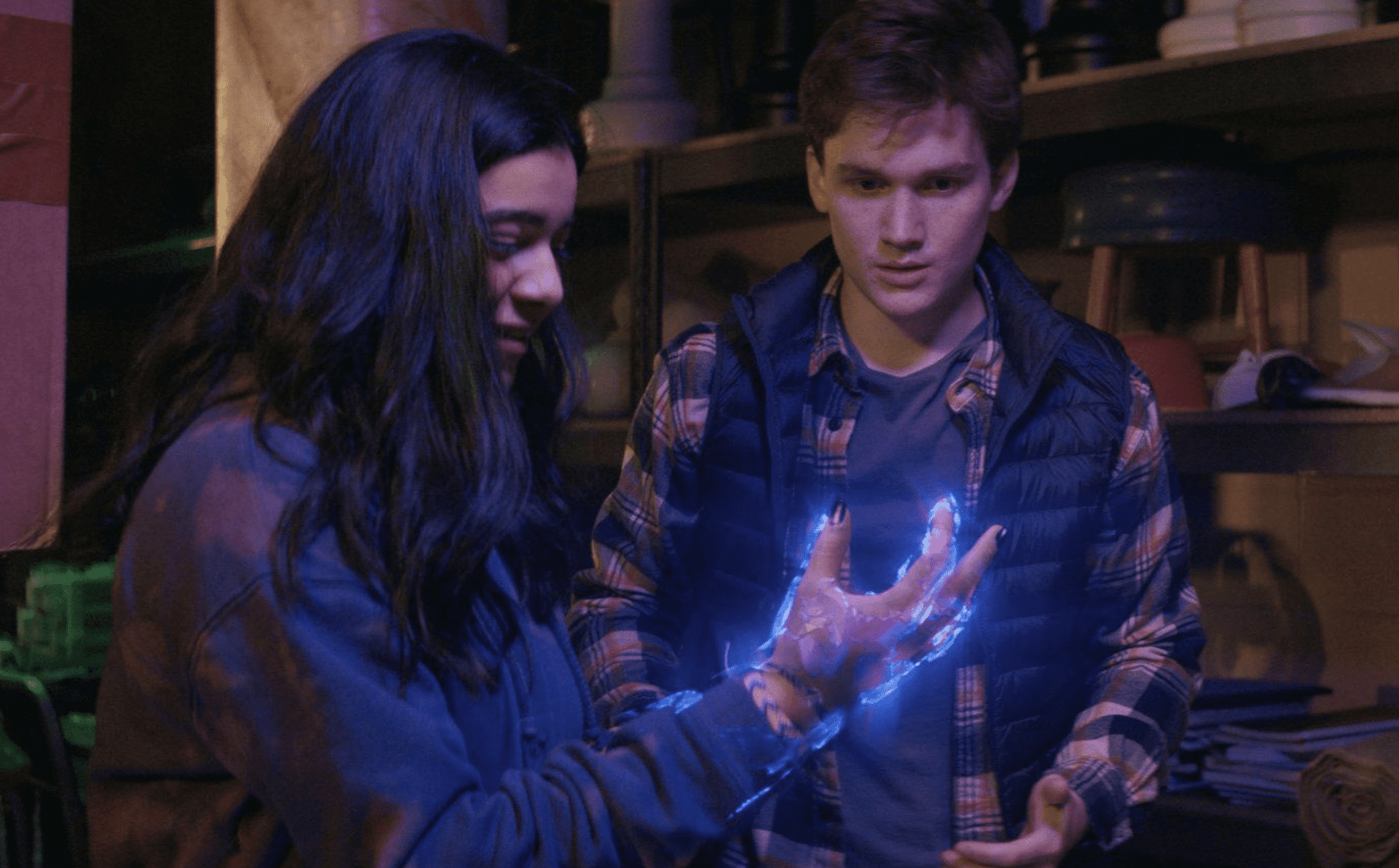A boy and girl stare at her glowing hand in this image from Marvel Studios.