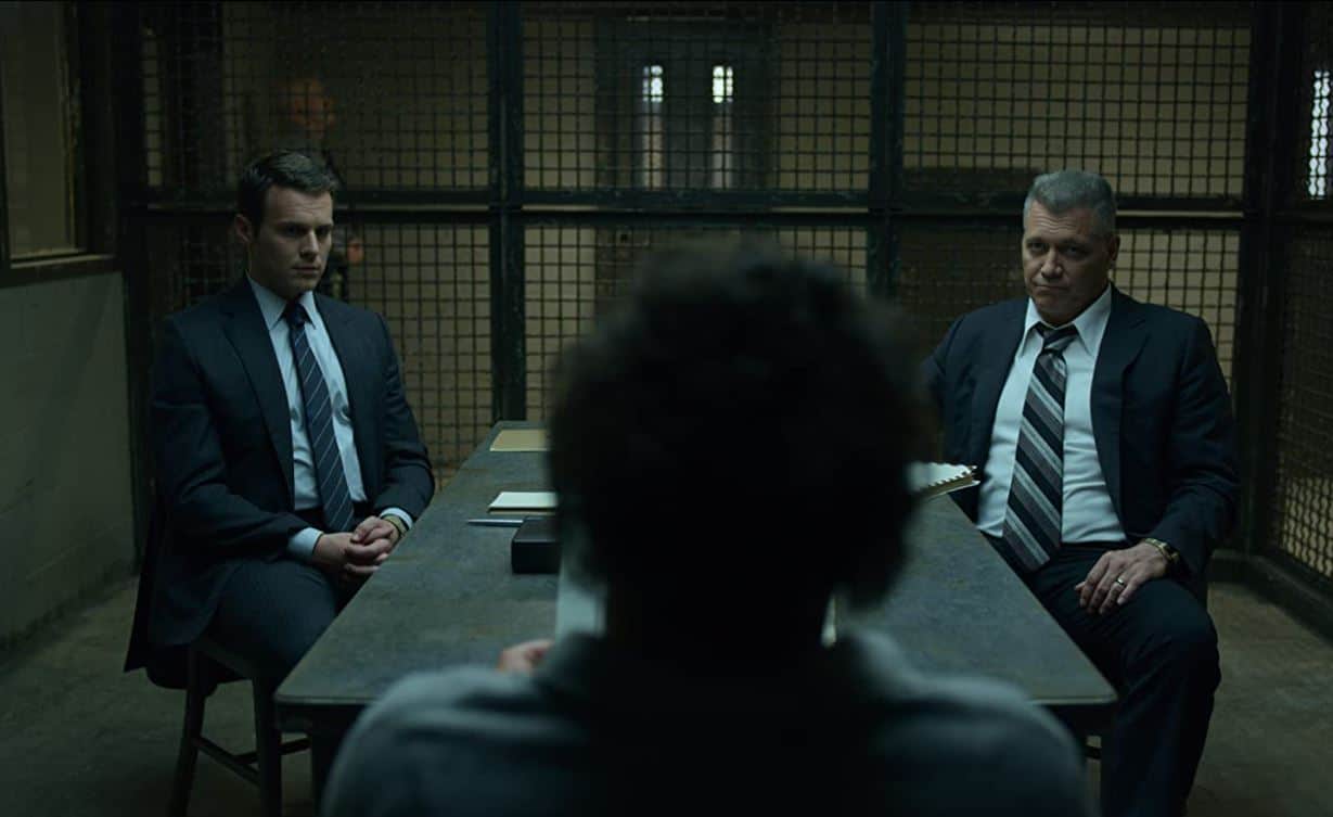Holden Ford and Bill Tench interview a silhouetted David Berkowitz in the show “Mindhunter”