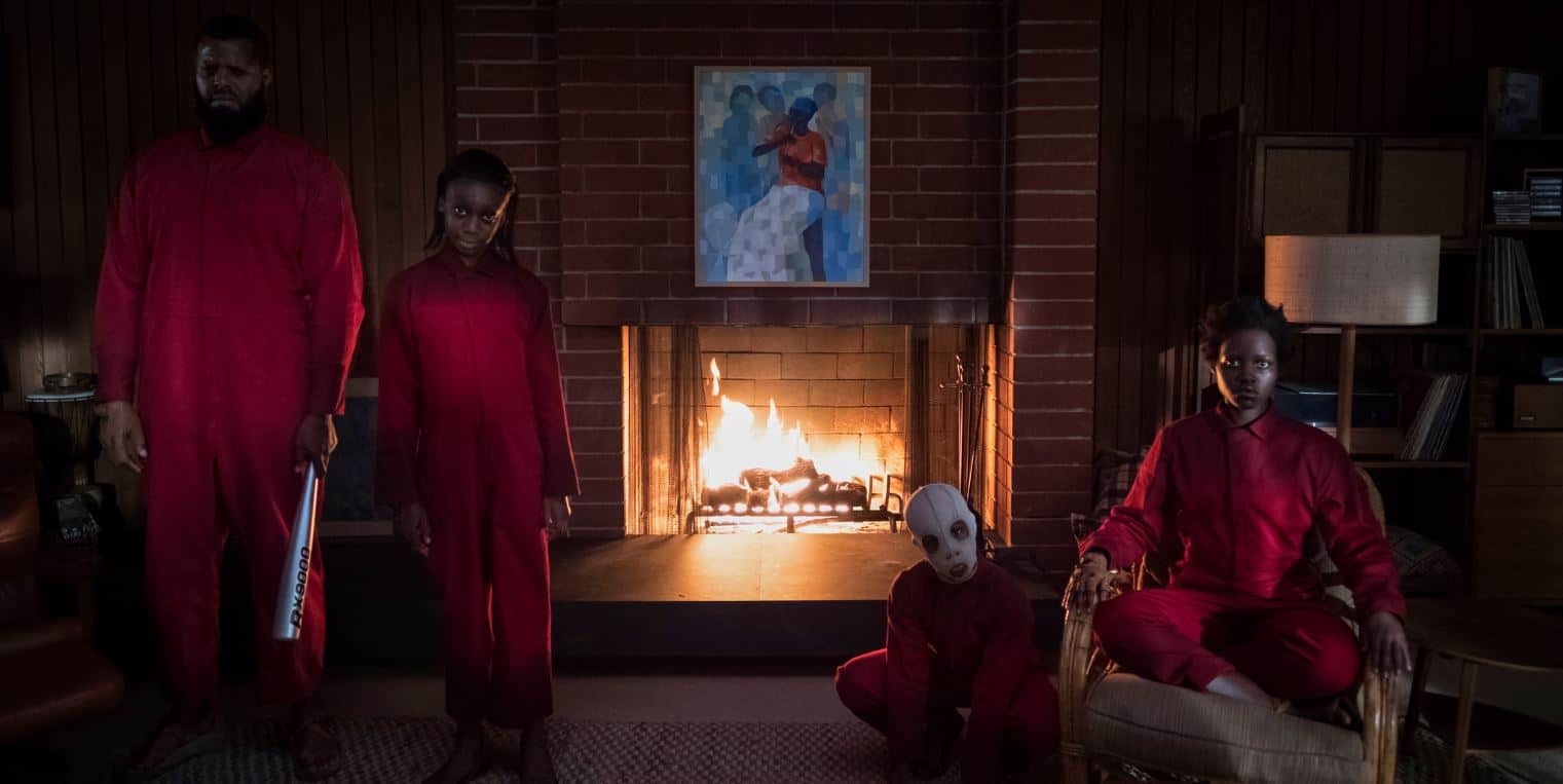  A family in red jumpsuits in front of a blazing fireplace in this image from Monkeypaw Productions.