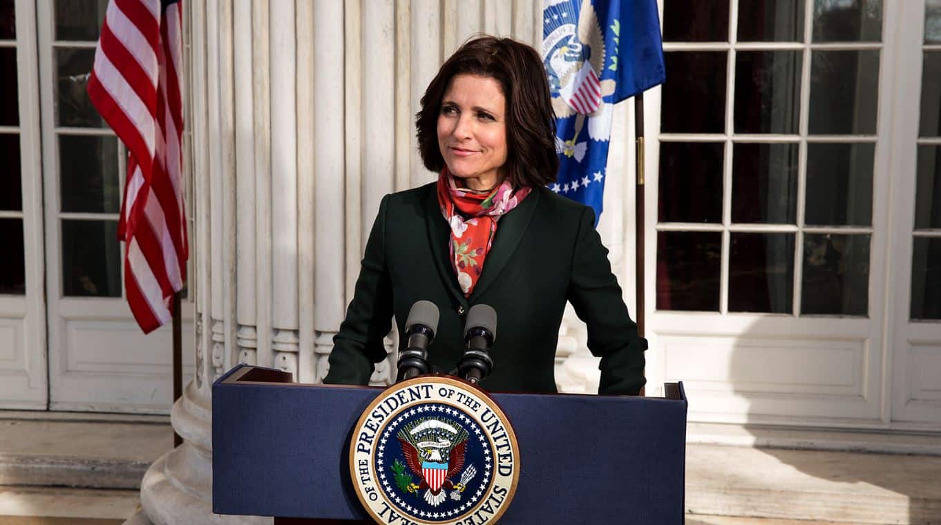 Vice President Selina Meyer stands at a podium to give a press conference.