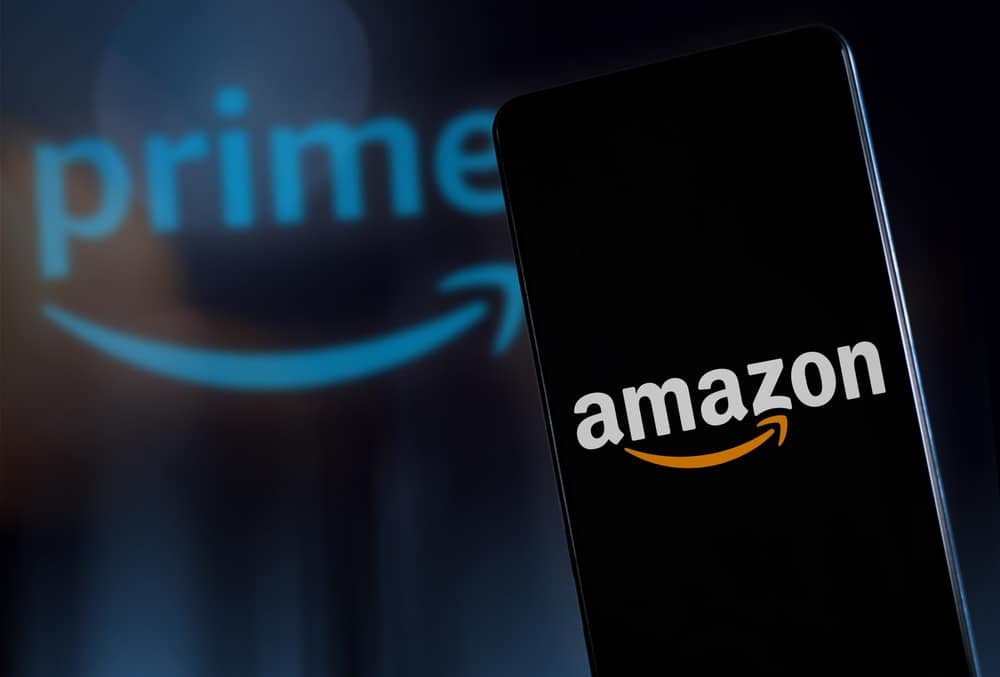 A TV and telephone screen displaying the Amazon logo 
