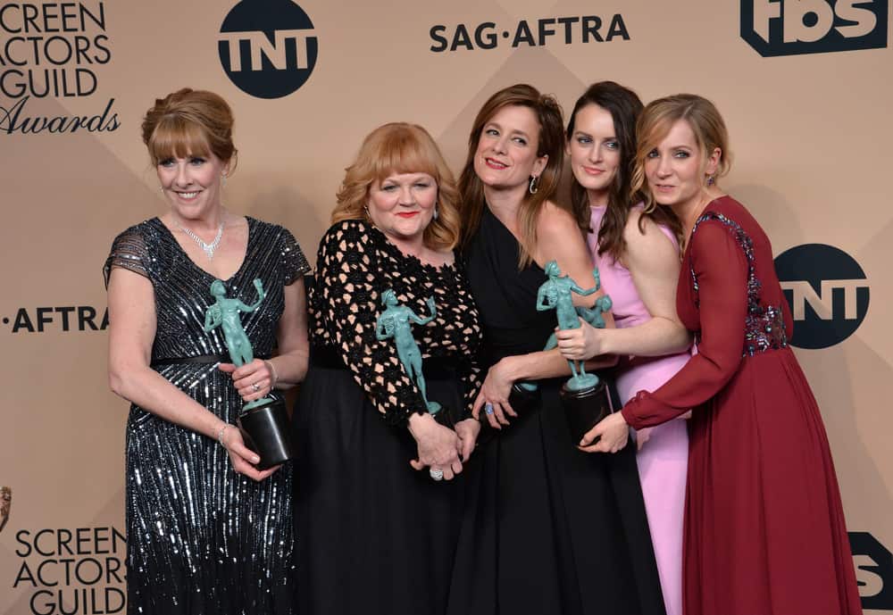 Phyllis Logan, Lesley Nicol, Raquel Cassidy, Sophie McShera, and Joanne Froggatt smiling and holding awards on the red carpet