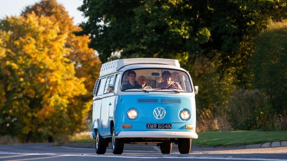 A VW minibus driving down the road