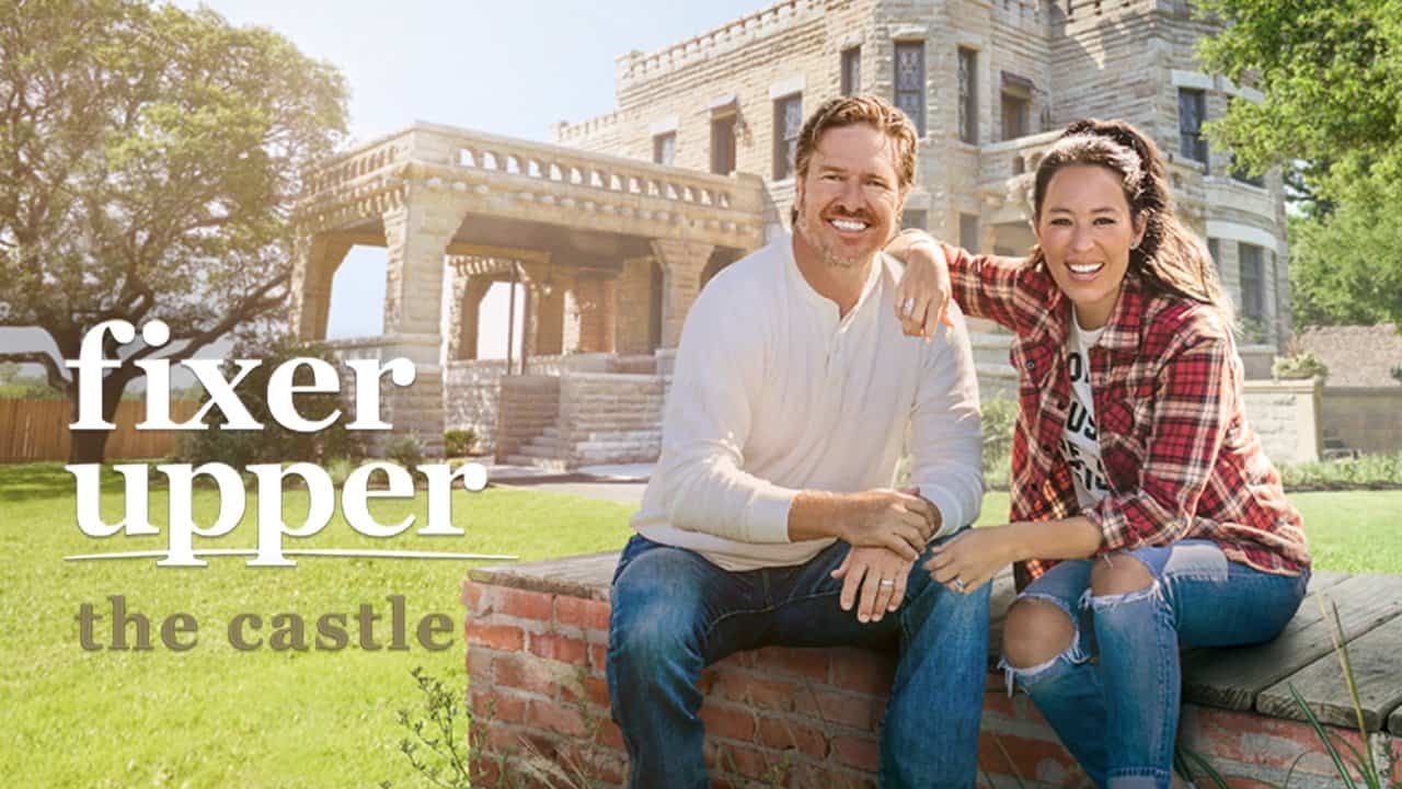 Chip and Joanna smiling in front of a castle