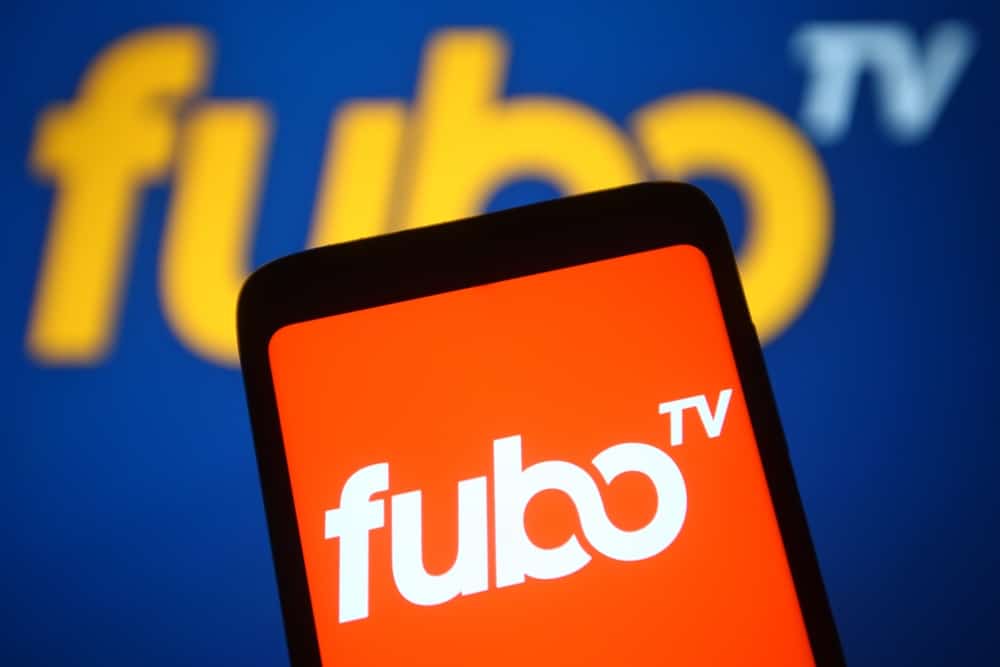 fuboTV logo on a smartphone and in the background
