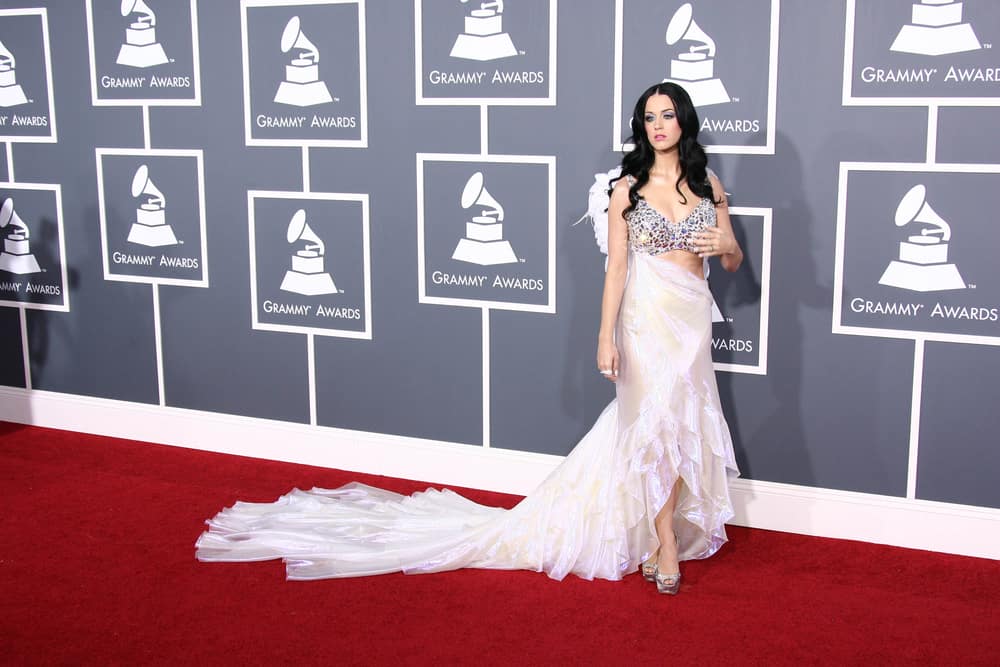 Katy Perry in front of the Grammy Awards logo on the red carpet