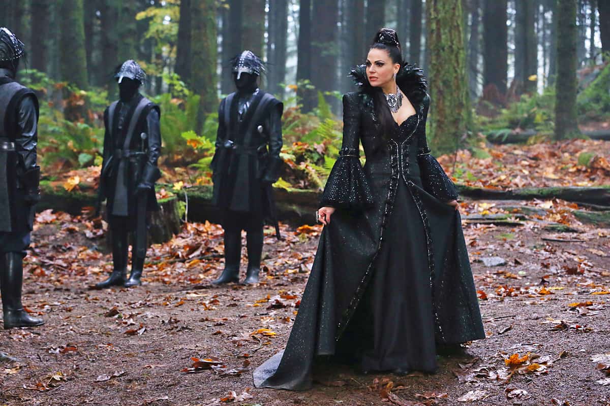 The Evil Queen and her three guards stand in the forest.