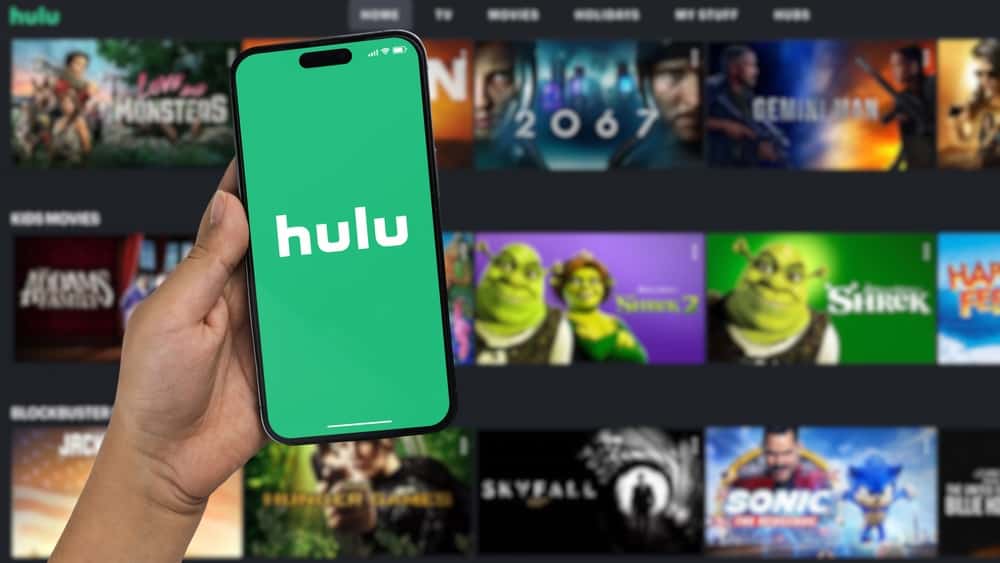 Hulu logo on a smartphone with a TV showing the Hulu library