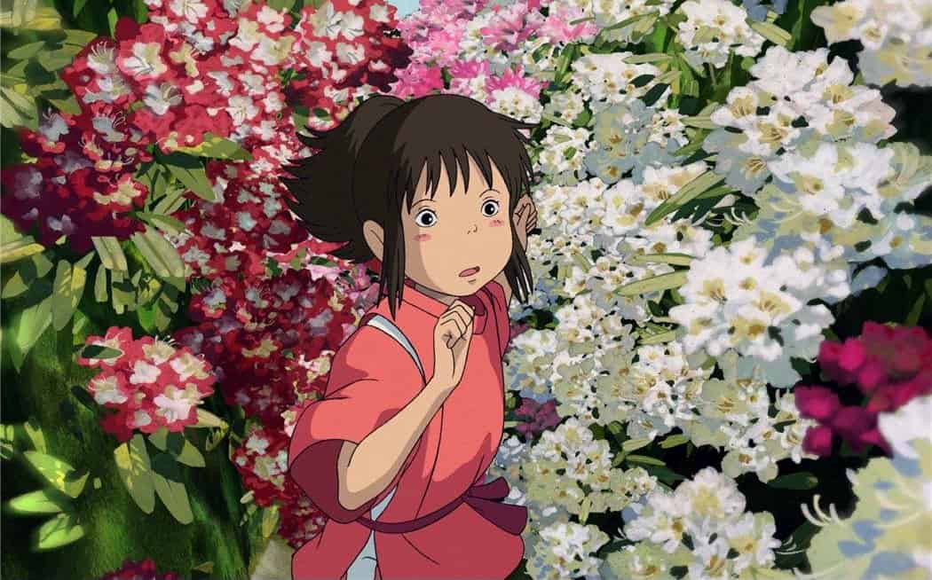 Chihiro pushing herself through a hedge of flowers