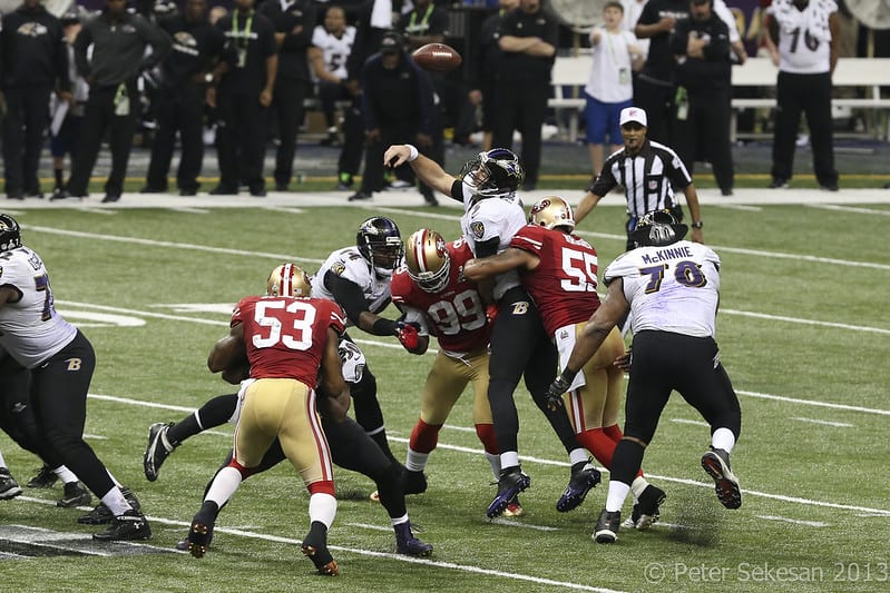 Seven football players colliding in the backfield