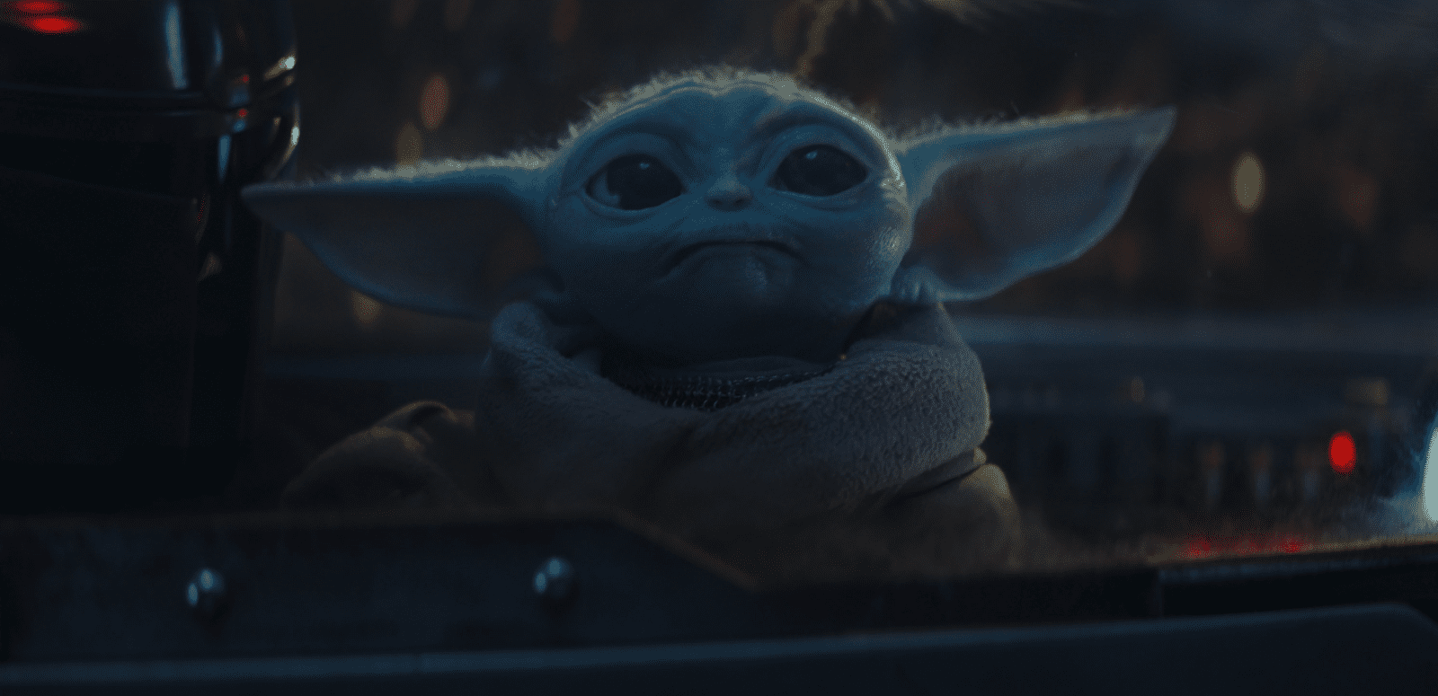  An infant Yoda stares curiously up to the heavens. 