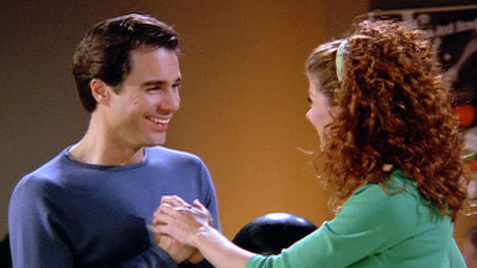 Will and Grace laughing and holding hands