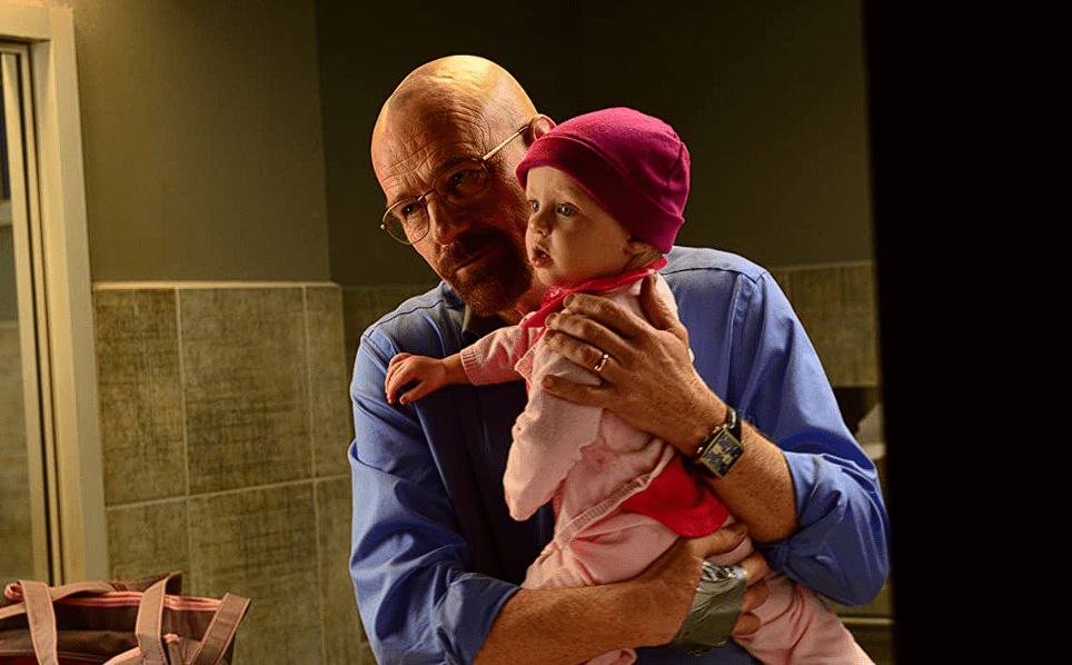 Bryan Cranston holding a baby in this image from Netflix
