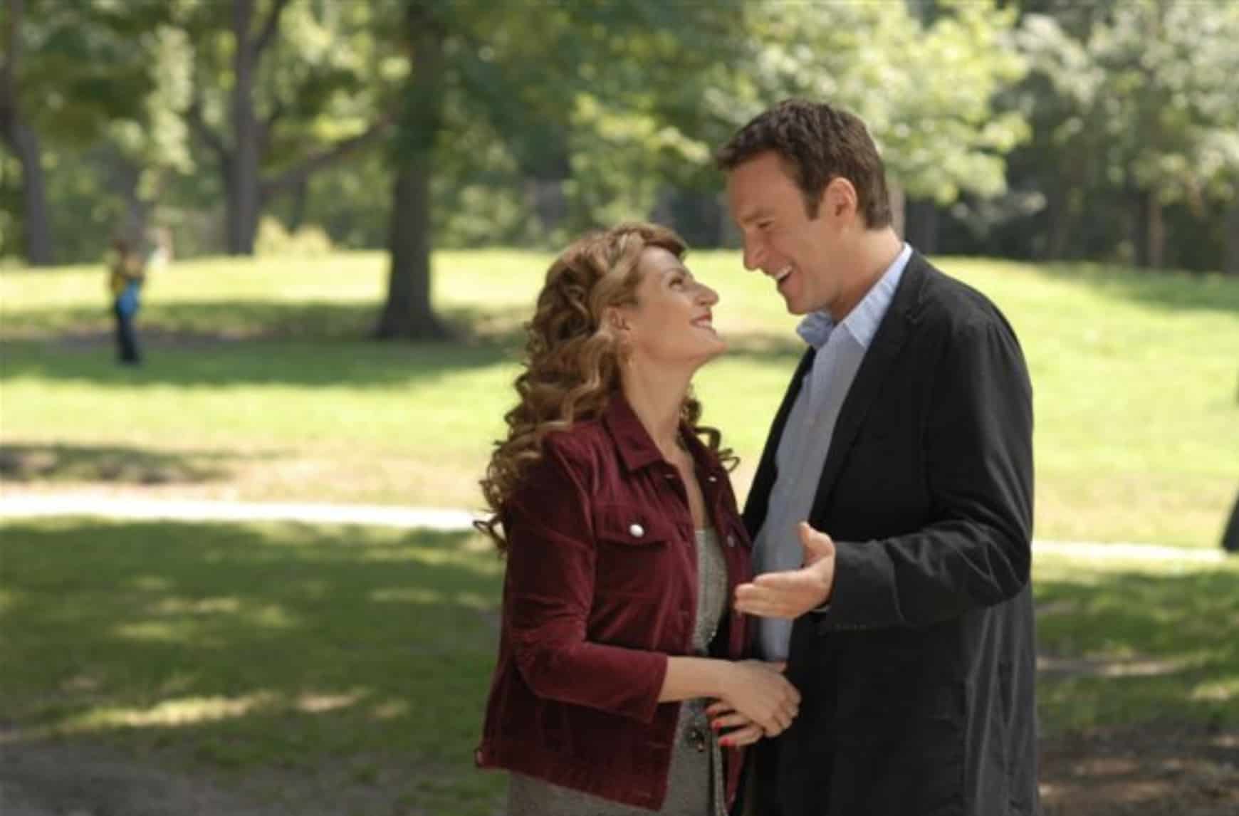 A white couple standing in a park and smiling at each other in this image from Amazon Prime Video