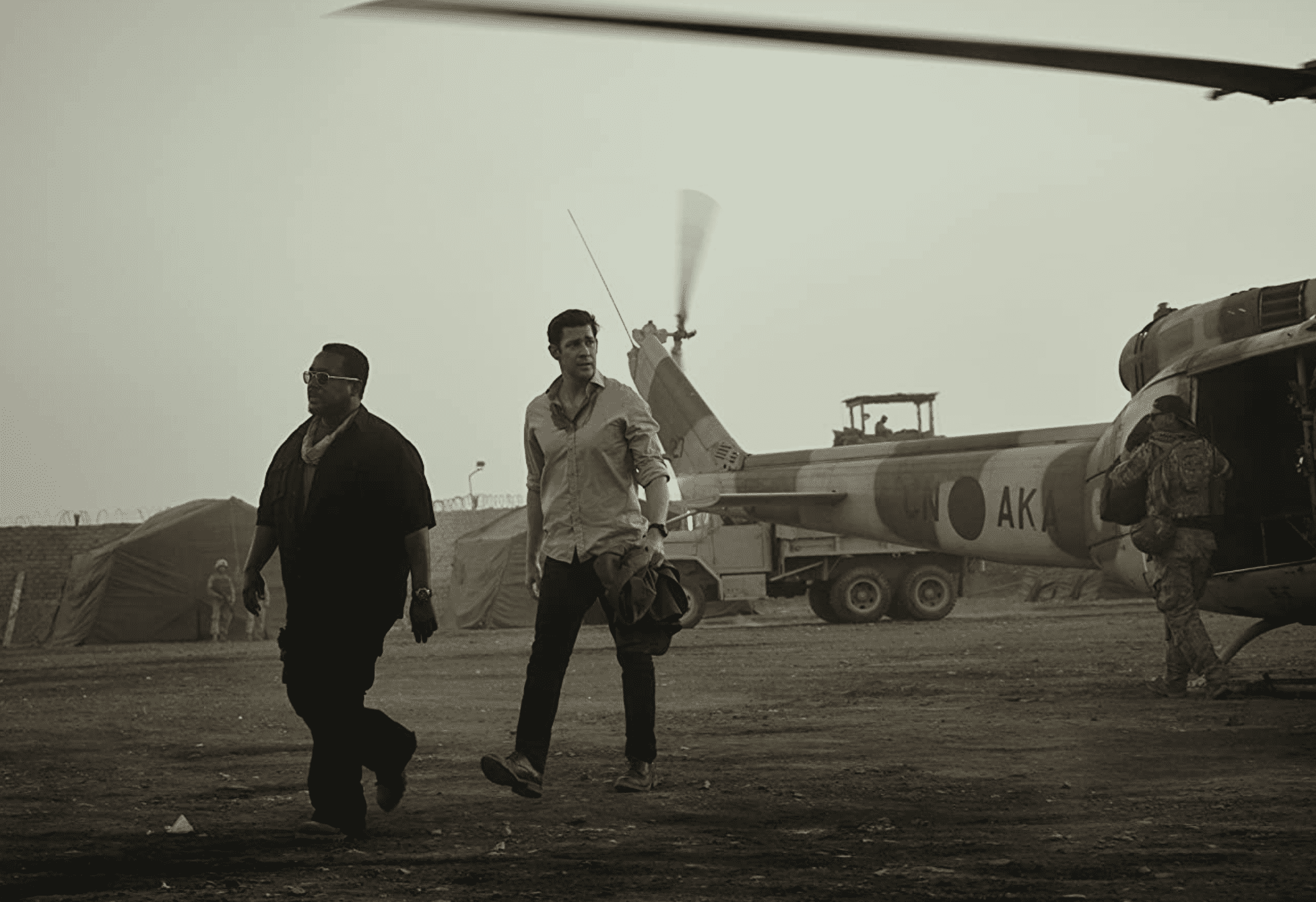 James Greer and Jack Ryan walk near a helicopter