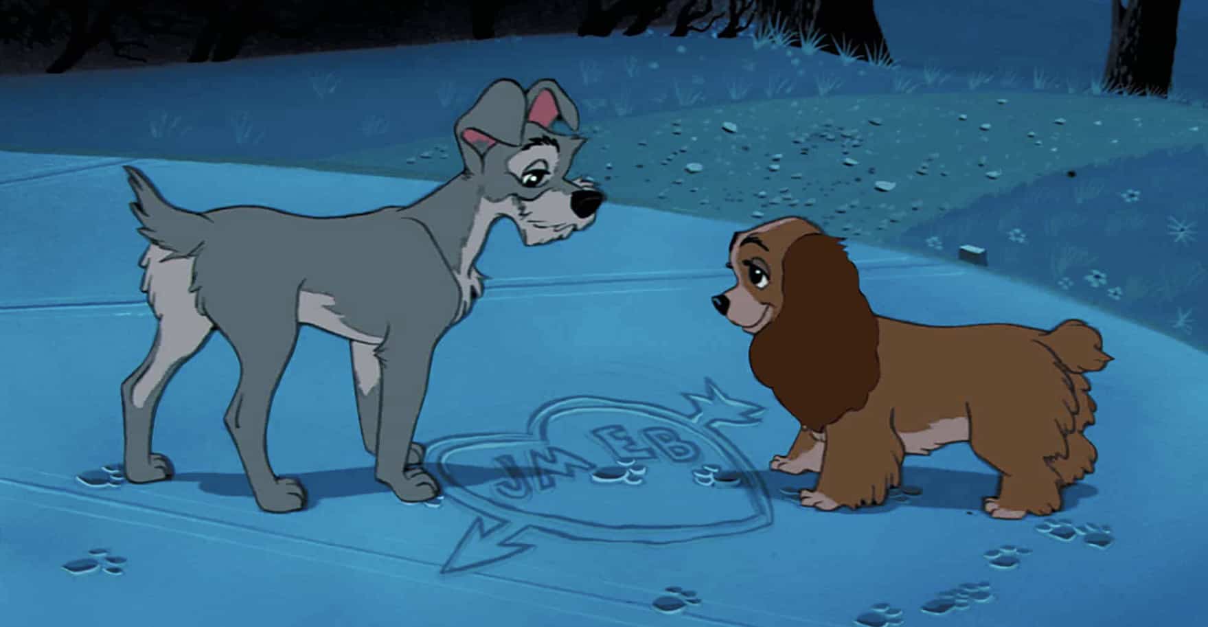 Two dogs stand opposite each other with a heart drawn in the snow between them in this image from Disney Plus.