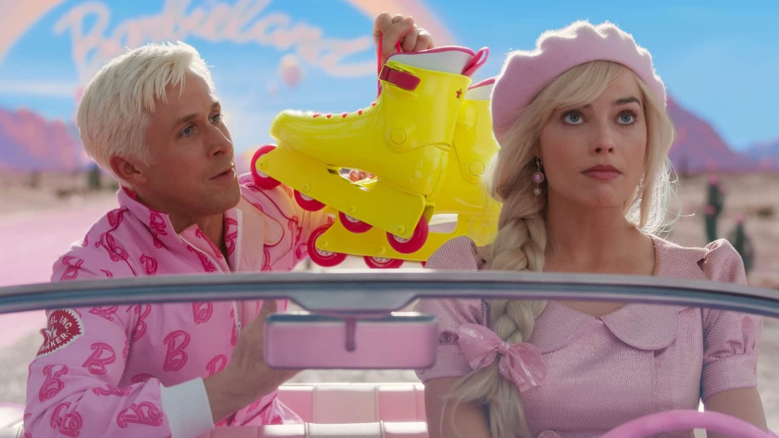 A man holds up yellow rollerblades to a woman driving a car in this image from Sony Pictures.