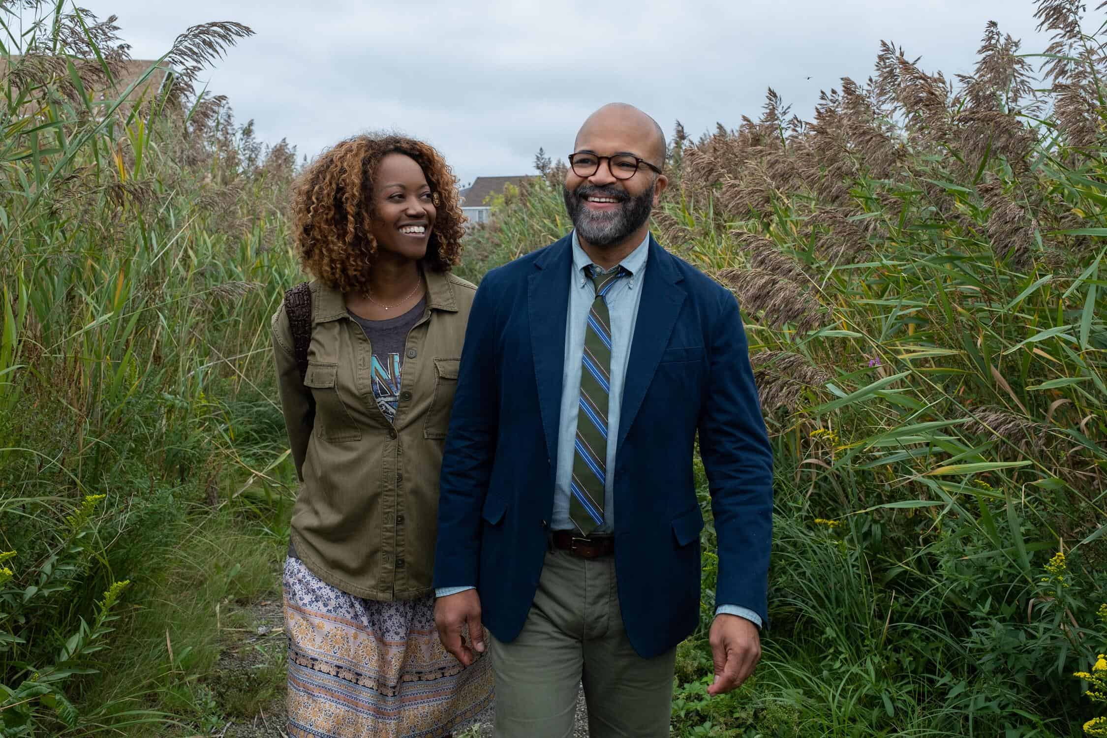 A well-dressed man and woman walk through tall grasses in this image from 3 Arts Entertainment.